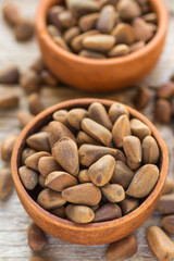 Brown Siberian pine nuts on wooden table