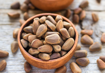 Brown Siberian pine nuts on wooden table