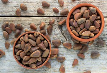 Brown Siberian pine nuts on wooden table