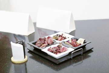 Close up of small still-life with dry leaves and square plate