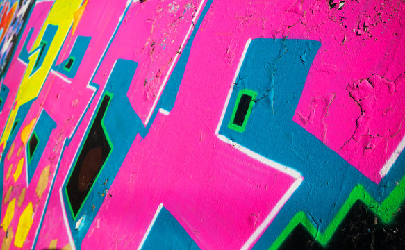 Abstract colorful graffiti fragment over old wall