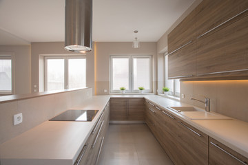 Fototapeta na wymiar Wooden cupboards in beige kitchen