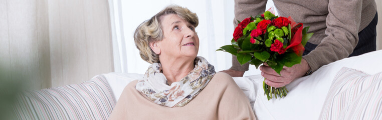 Senior woman getting anniversary bouquet