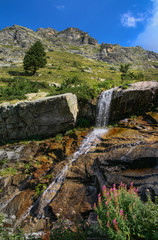 Little waterfall on the rocks, spring mountain