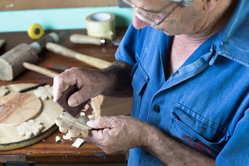 Carpenter polishing a wooden figure