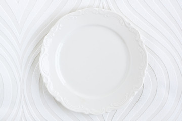 empty plate on a white striped background