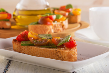 Spring Bruschetta with tomatoes and young green peas