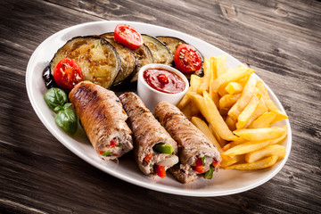 Wrapped pork chop, chips and vegetables