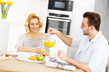 Obraz na płótnie Canvas Young couple eating breakfast