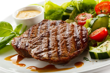Grilled steaks and vegetable salad