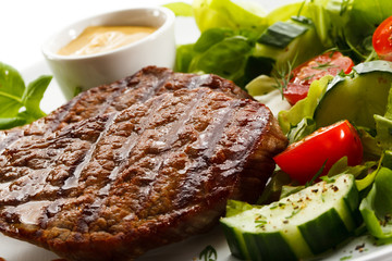 Grilled steaks and vegetable salad
