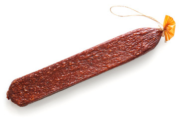 Premium stick of salami with string isolated on white.