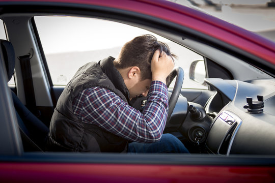 Stressed Man Sitting On Car Drivers Seat