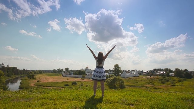 Happy Young Woman Enjoying Summer Day In A Green  Field.