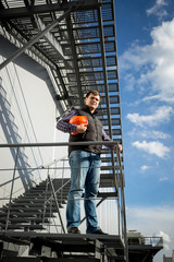 architect standing on metal staircase on side of the factory