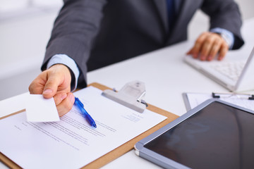 Man's hand giving business card