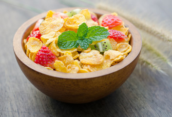 Cereals with fruit in wooden bowl
