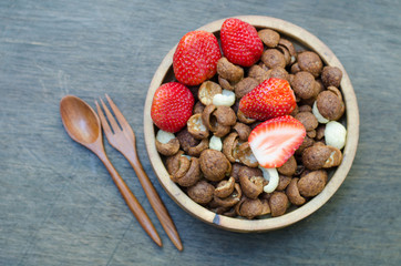 Cereals with fruit in wooden bowl
