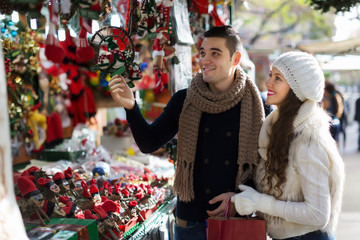 Happy  couple  choosing Christmas souvenirs