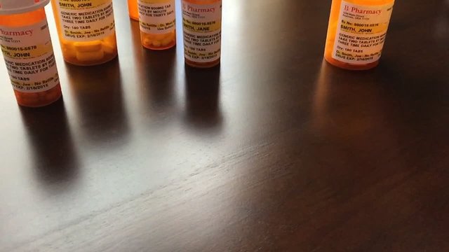Panning of Medicine Bottles and Pills Falling Slo-Mo