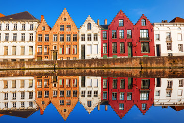 Bruges canals: Spinolarei reflected in the canal. Belgium