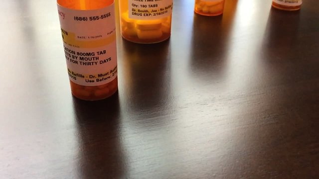 Panning of Medicine Bottles and Pills Falling Slo-Mo