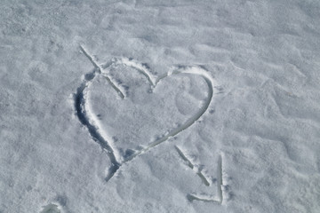 heart pierced by an arrow drawn in the snow