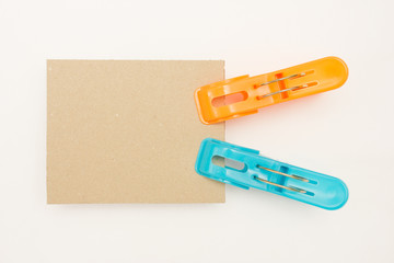 Cardboard with Blue and Orange Clothes Pins