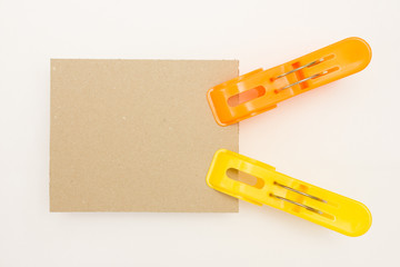 Cardboard with Yellow and Orange Clothes Pins