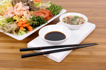 Asian vegetables with soy sauce and chopsticks