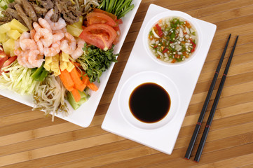 Asian food vegetables with soy sauce and chopsticks