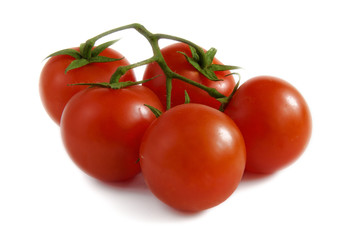 Cherry tomatoes with a stalk on a white background.