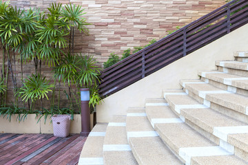 beautiful brick wall and decorated green plants next to stair an