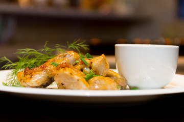 fried chicken wings served with source on white plate