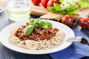 Spaghetti bolognese with cheese and basil