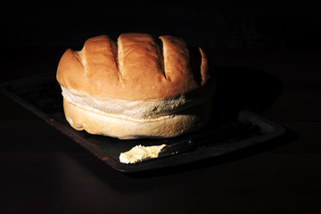 Round loaf of bread on a baking tray