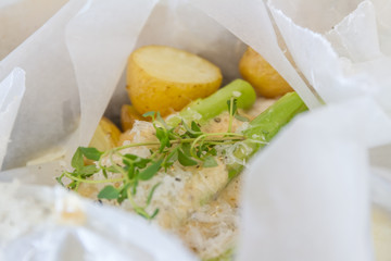 slightly fried fish slices with asparagus and potato ready for c