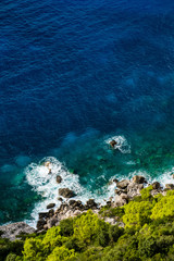 Fototapeta na wymiar Aerial view of seashore with blue sea and green vegetation