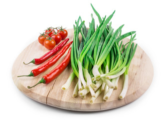 Bunch of green onion on wooden platter.