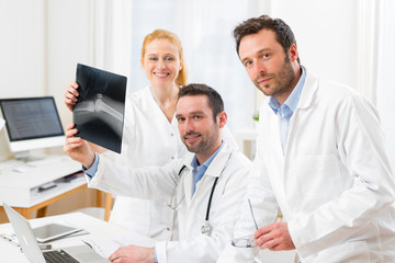 Medical team analysing together a x ray at the hospital