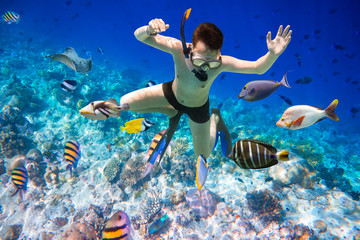 Snorkeler Maldives Indian Ocean coral reef.