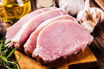 Raw pork slices on a chopping board