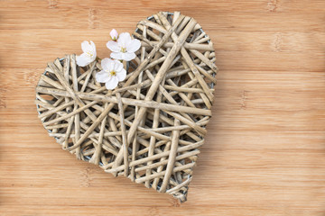 Wooden heart with cherry tree flower