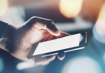 Closeup of man's hand using smartphone with effects