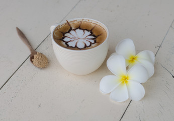 Fototapeta na wymiar a cup of latte art on wooden table