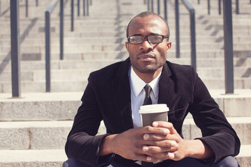 black bussinesman sitting with coffee during a lunch