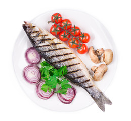 Grilled seabass on plate with tomatoes.