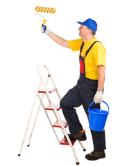 Worker on ladder with roller and bucket.