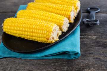 corn cob on wooden table from above