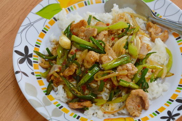 fried pork with sweet chili and onion on rice